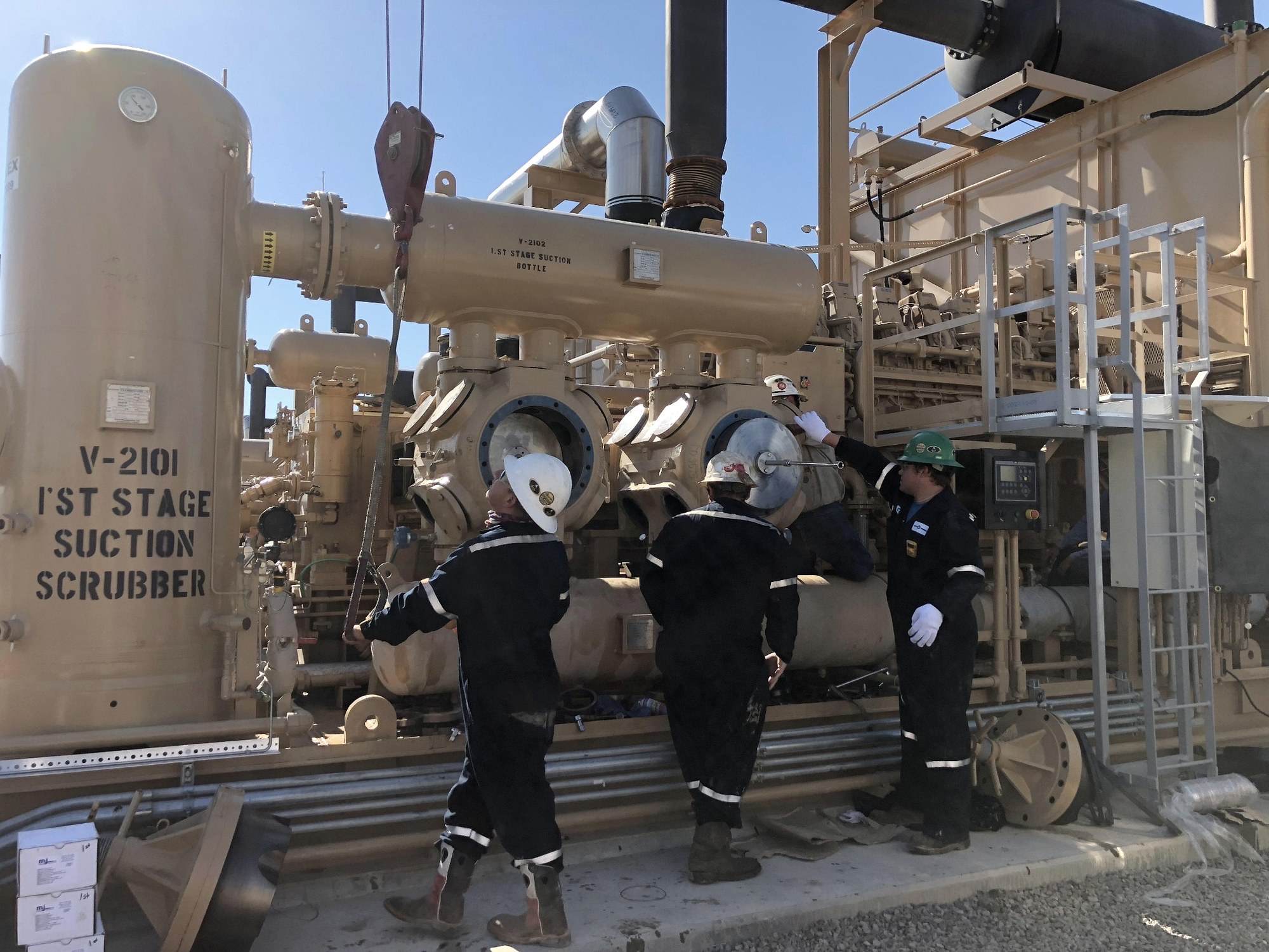 Roto-Versal field crew working on natural gas compression equipment