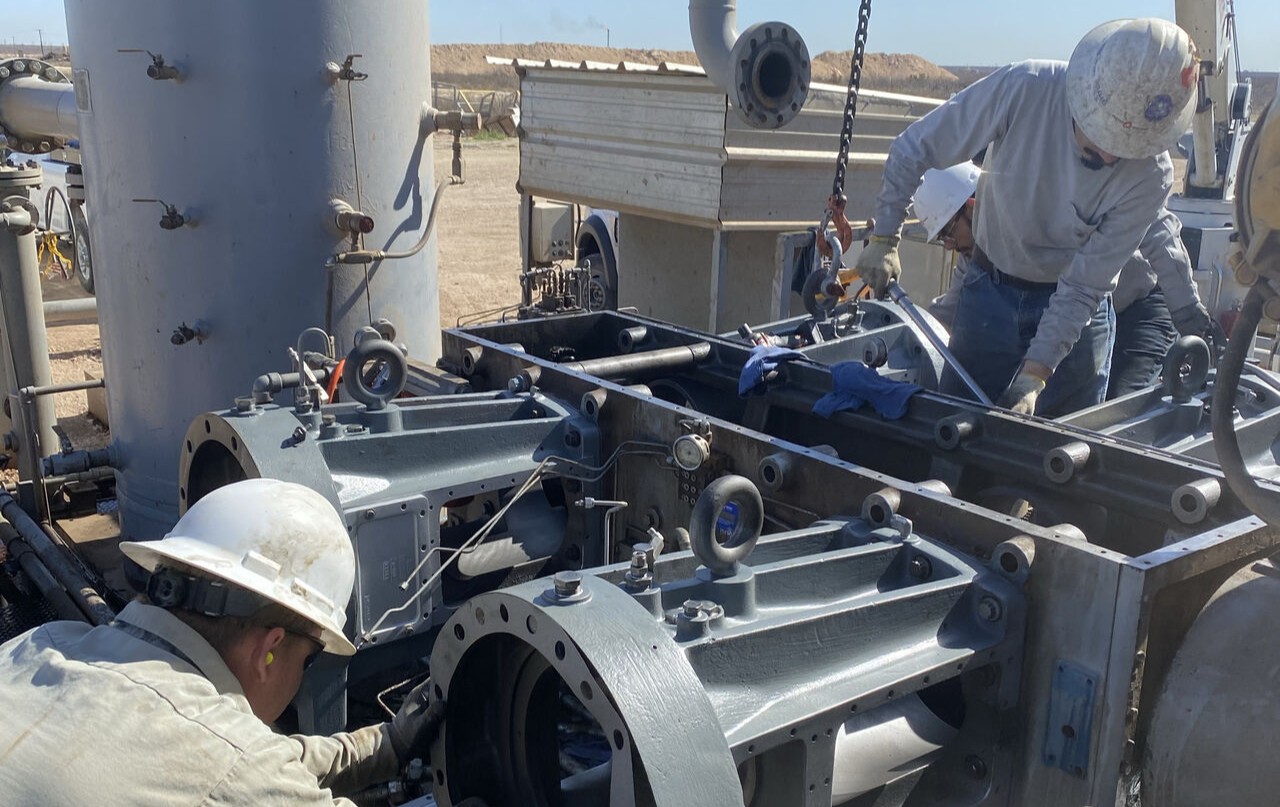 Technicians performing mechanical compressor services